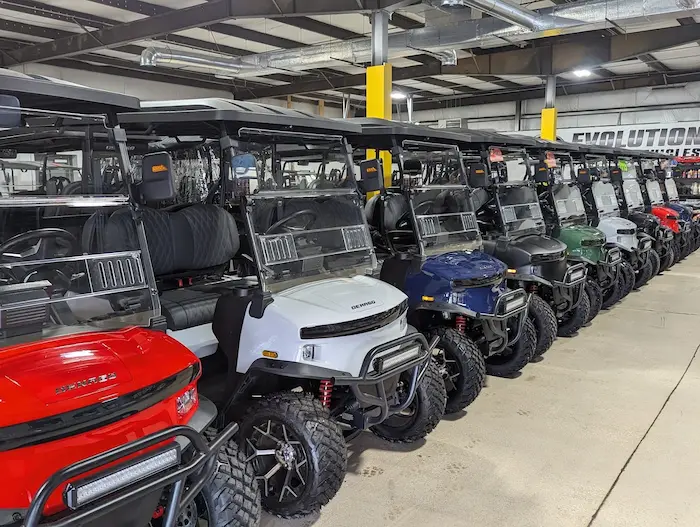 Multiple new and used golf carts parked at the CarNation Carts and Trailers dealership.